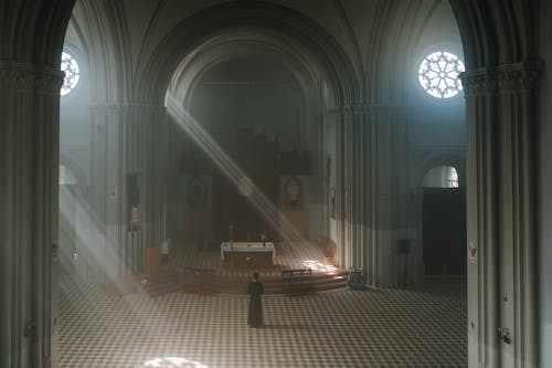 A Priest Standing Inside the Church