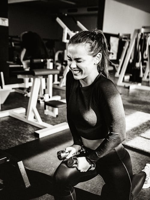 Woman in Long Sleeve Crop Top Squatting on Floor