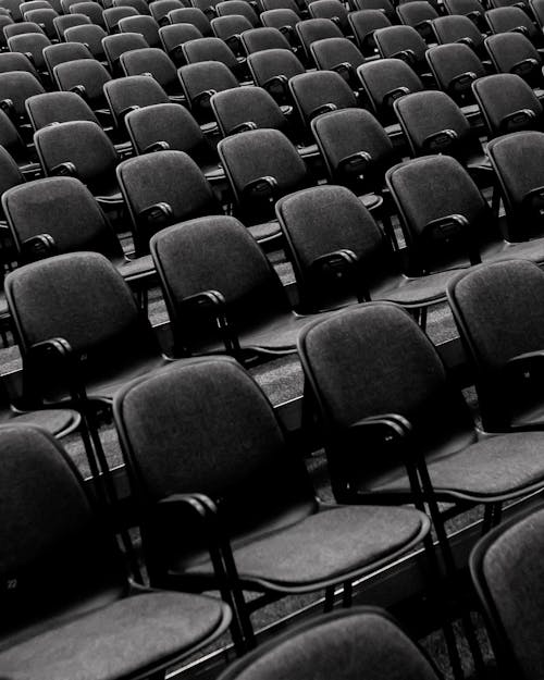 Grayscale Photo of Empty Seats 