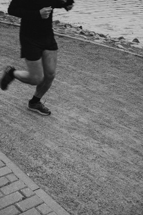 Grayscale Photography of Man Jogging on the Street