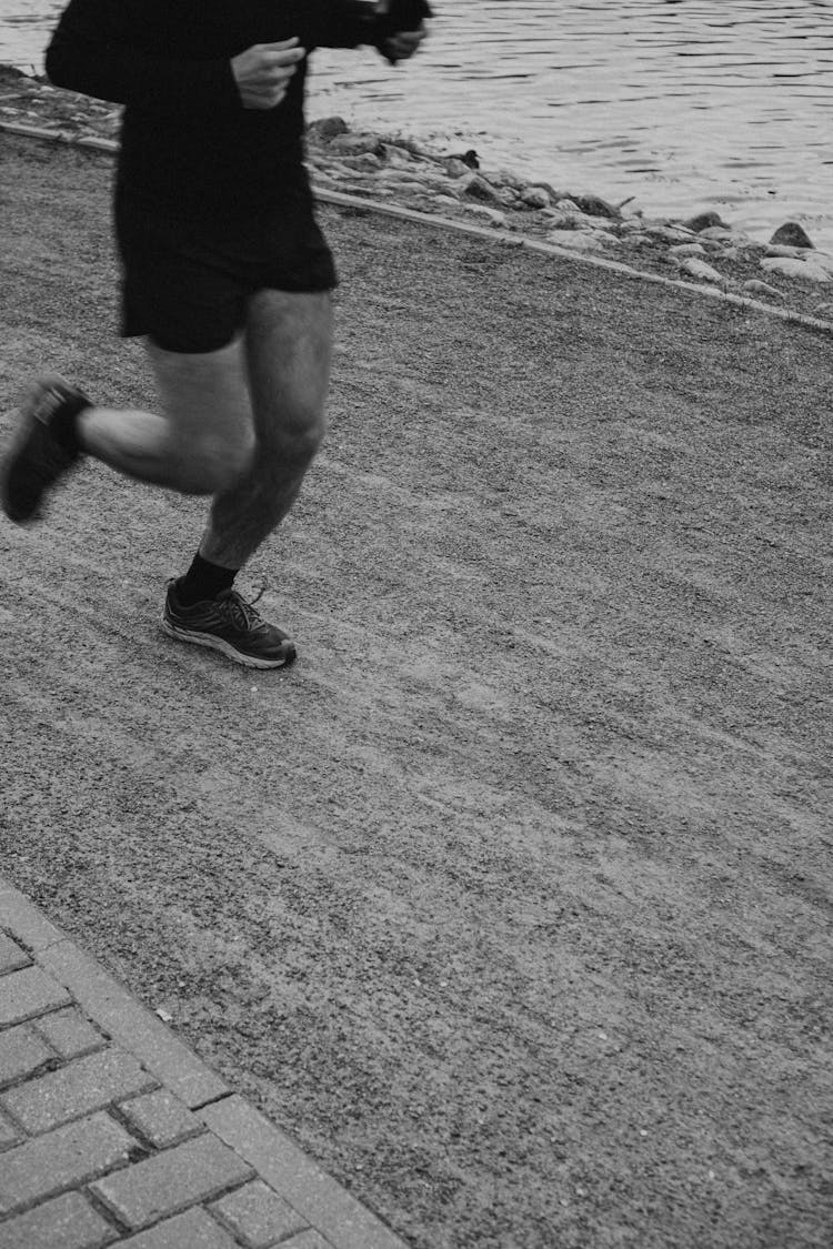 Grayscale Photography Of Man Jogging On The Street