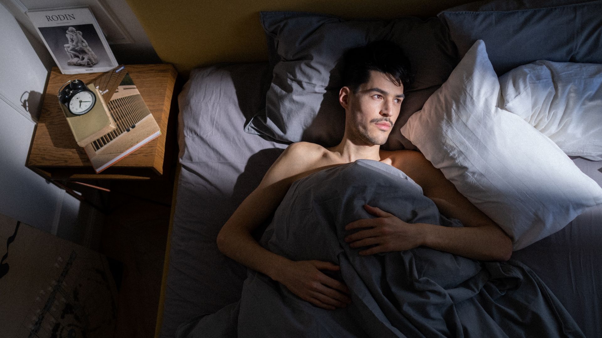 Wakefulness Promoting Agents: Unlocking the Secrets of Alertness A man in bed enjoying morning sunlight streaming in through the window — wakefulness promoting agents