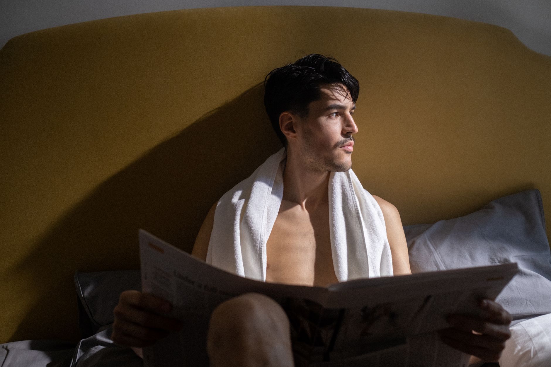 Indian professional doing morning yoga on a balcony at sunrise with a journal and water bottle nearby