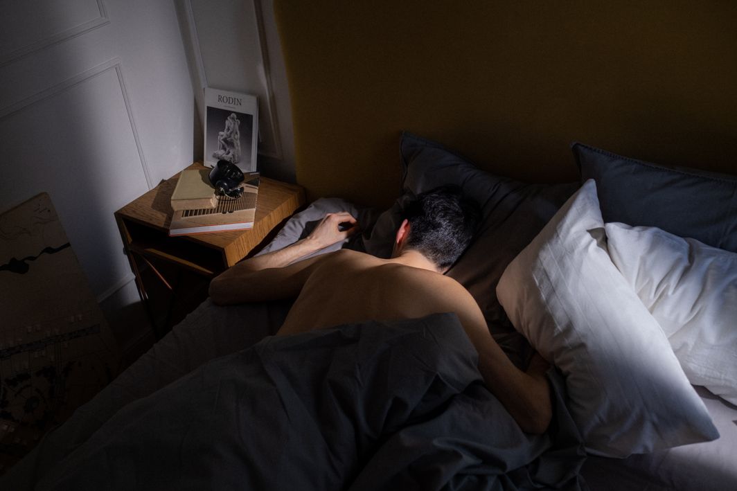 Mouth Taping for Sleep: Benefits, Risks, and What Science Says 1 A man peacefully sleeping in a cozy bedroom