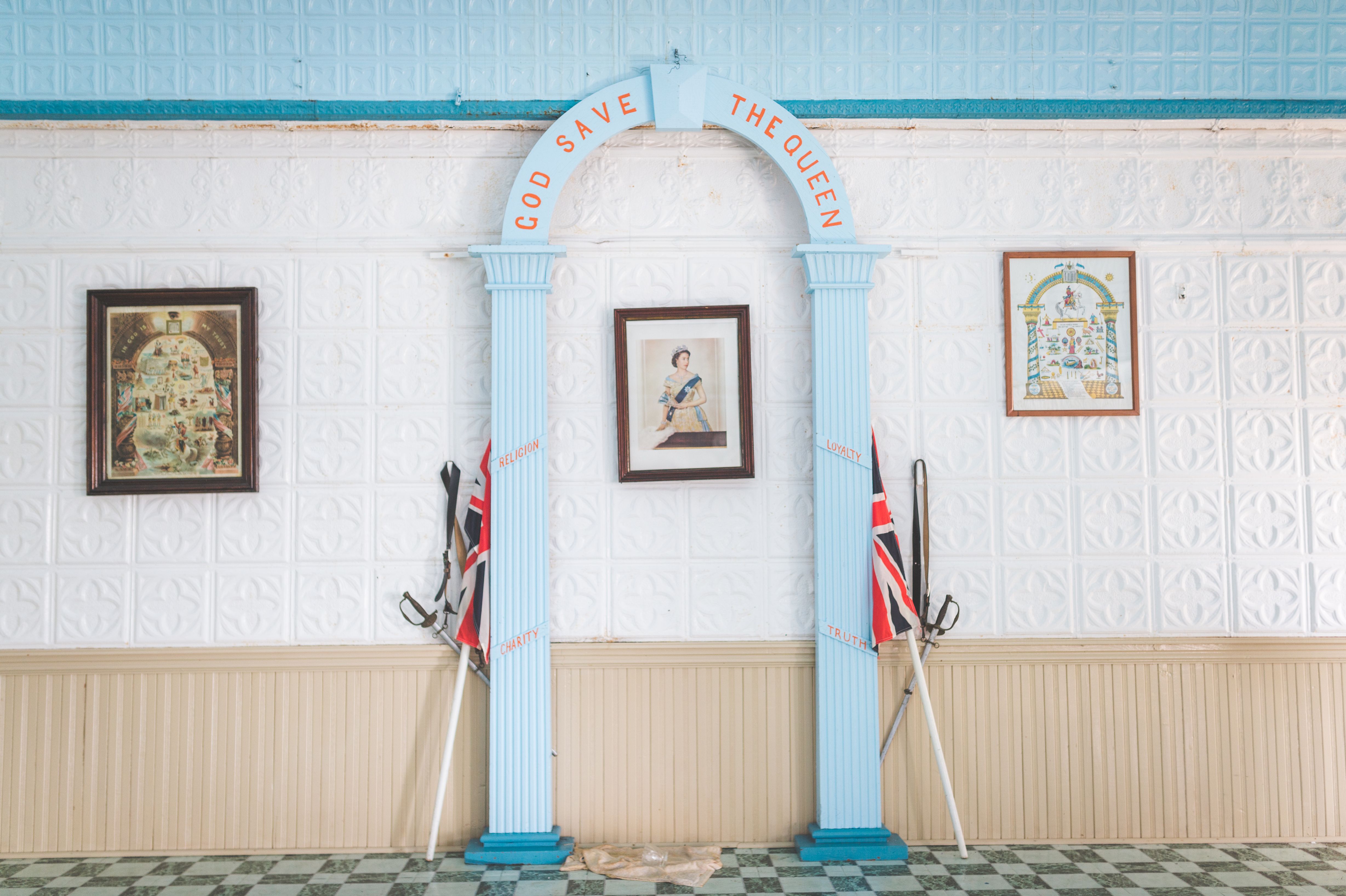 Elegant interior featuring British-themed archway and vintage paintings.