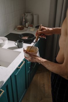 A person whisking eggs in a minimalist kitchen, embracing a serene morning routine.