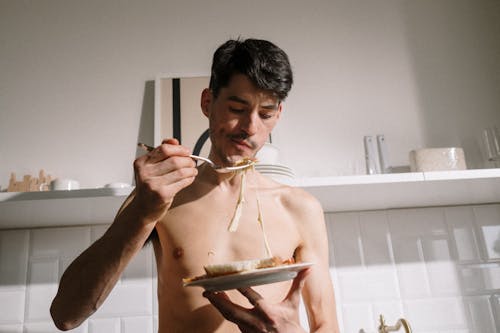 Topless Man Holding Brown Wooden Tray