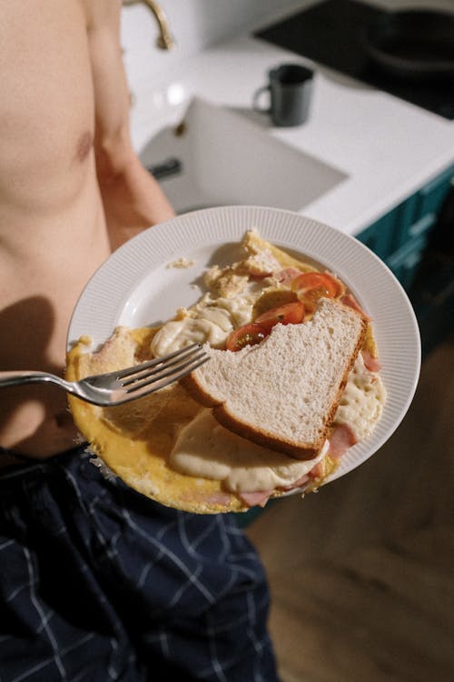 Person Holding Stainless Steel Fork and Bread Knife