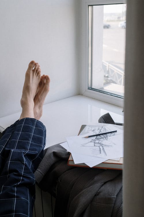 Close up on mans feet on windowsill