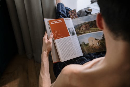 Rear view on man reading book