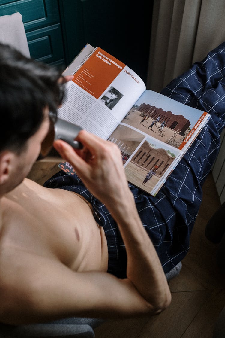 Adult Man Drinking And Reading Book