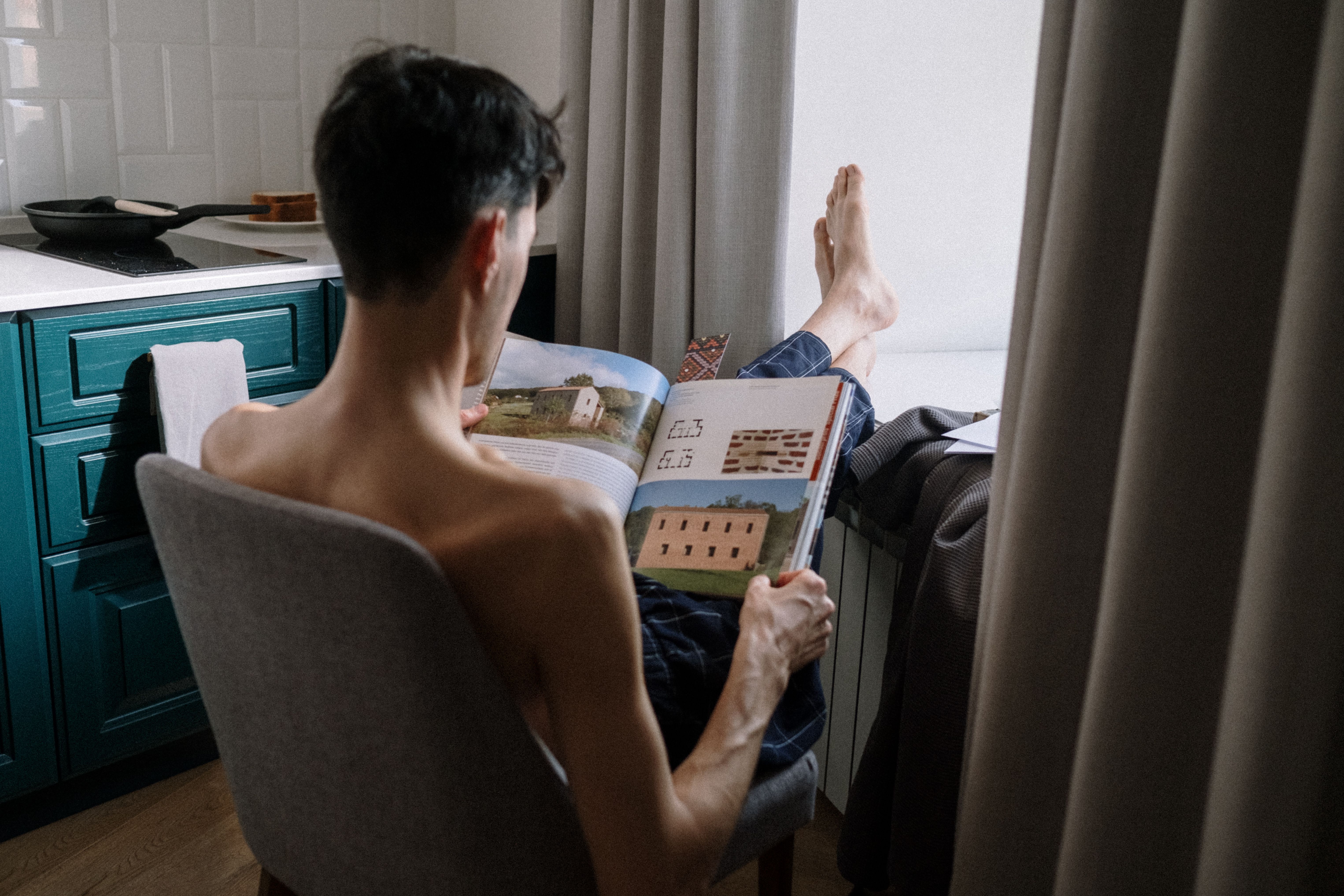 Rear view on man reading book · Free Stock Photo