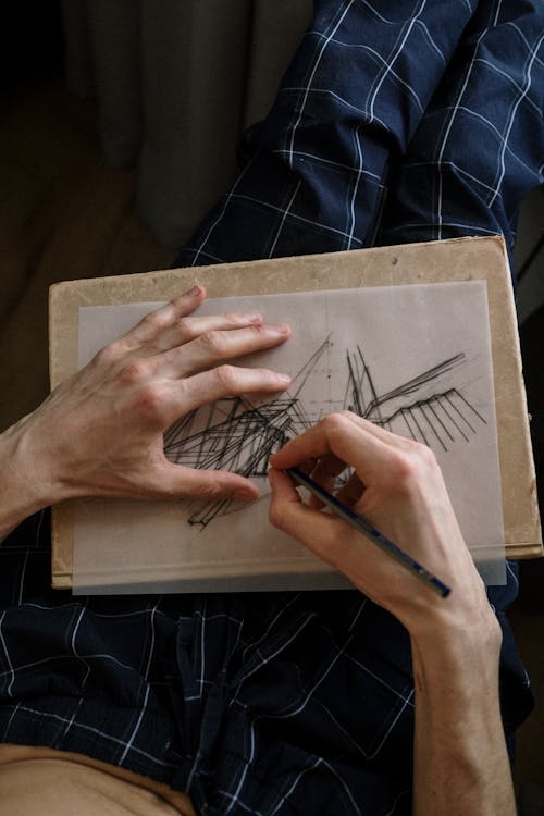 Free Close up on mans hands while drawing Stock Photo