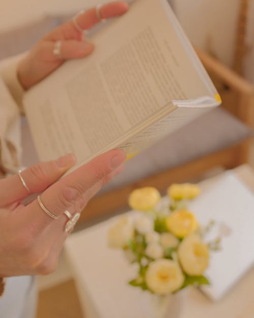 Free Person Wearing Rings Holding a Book Stock Photo