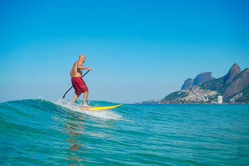 A Paddleboarder Riding the Sea Waves