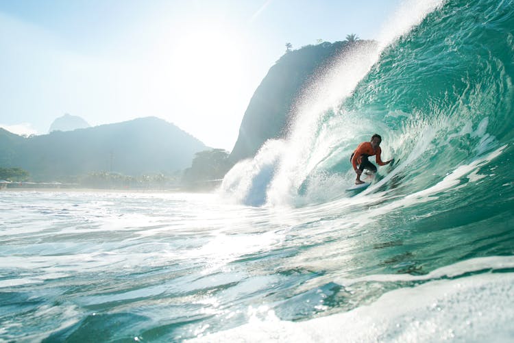 A Man Surfing On A Wave