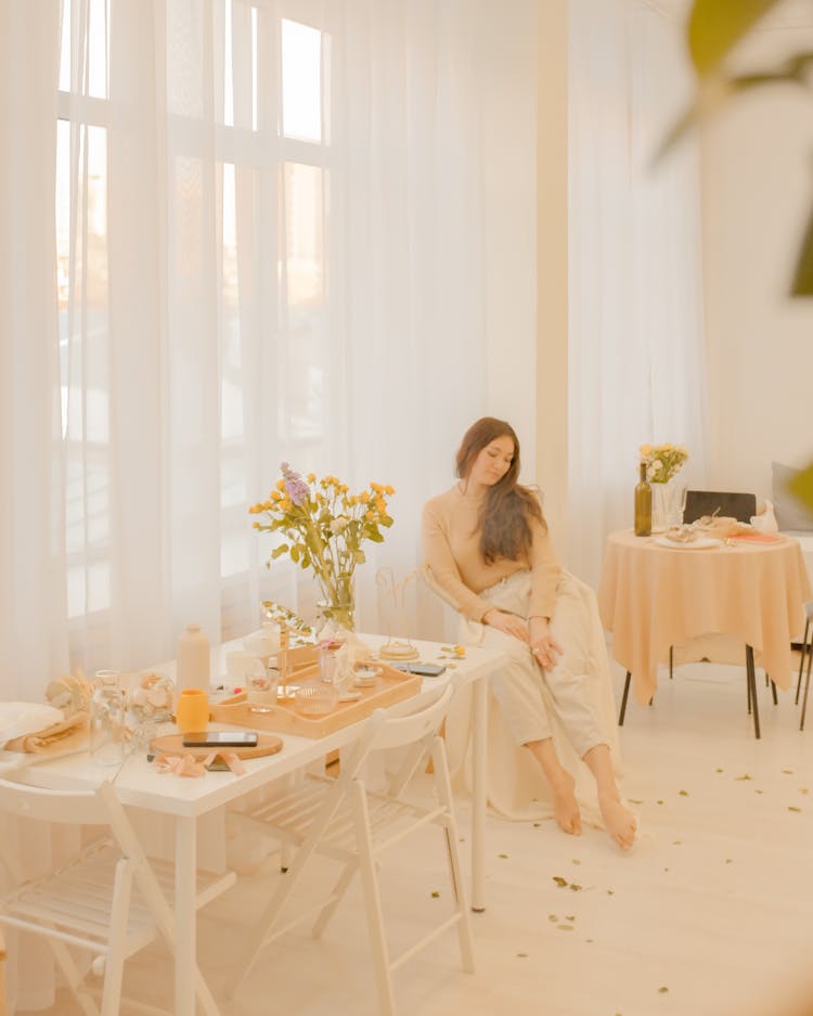 Woman Sitting On Chair In Elegant Restaurant Interior