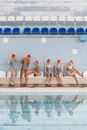 Women Synchronize Swimming Team Sitting by the Poolside