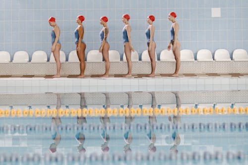 Women in Blue Swimsuit and Red Swim Cap
