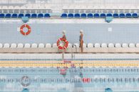 Women Standing by the Poolside Holding a Lifesaver