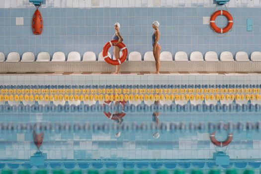 2 Women in Red Bikini Jumping on Swimming Pool