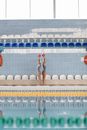Woman in Blue Bikini Standing on White and Blue Swimming Pool