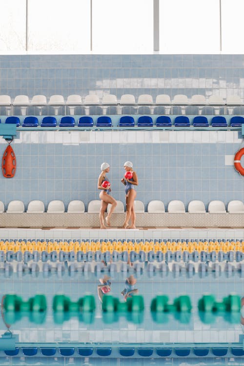 Women in Their Swimsuit Holding a Ball