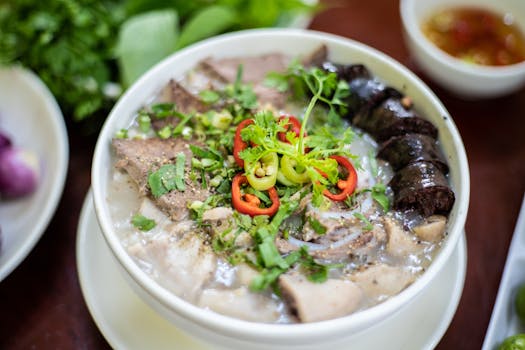 Close-up of traditional Vietnamese soup with diverse meat and herbs, offering a burst of flavors.