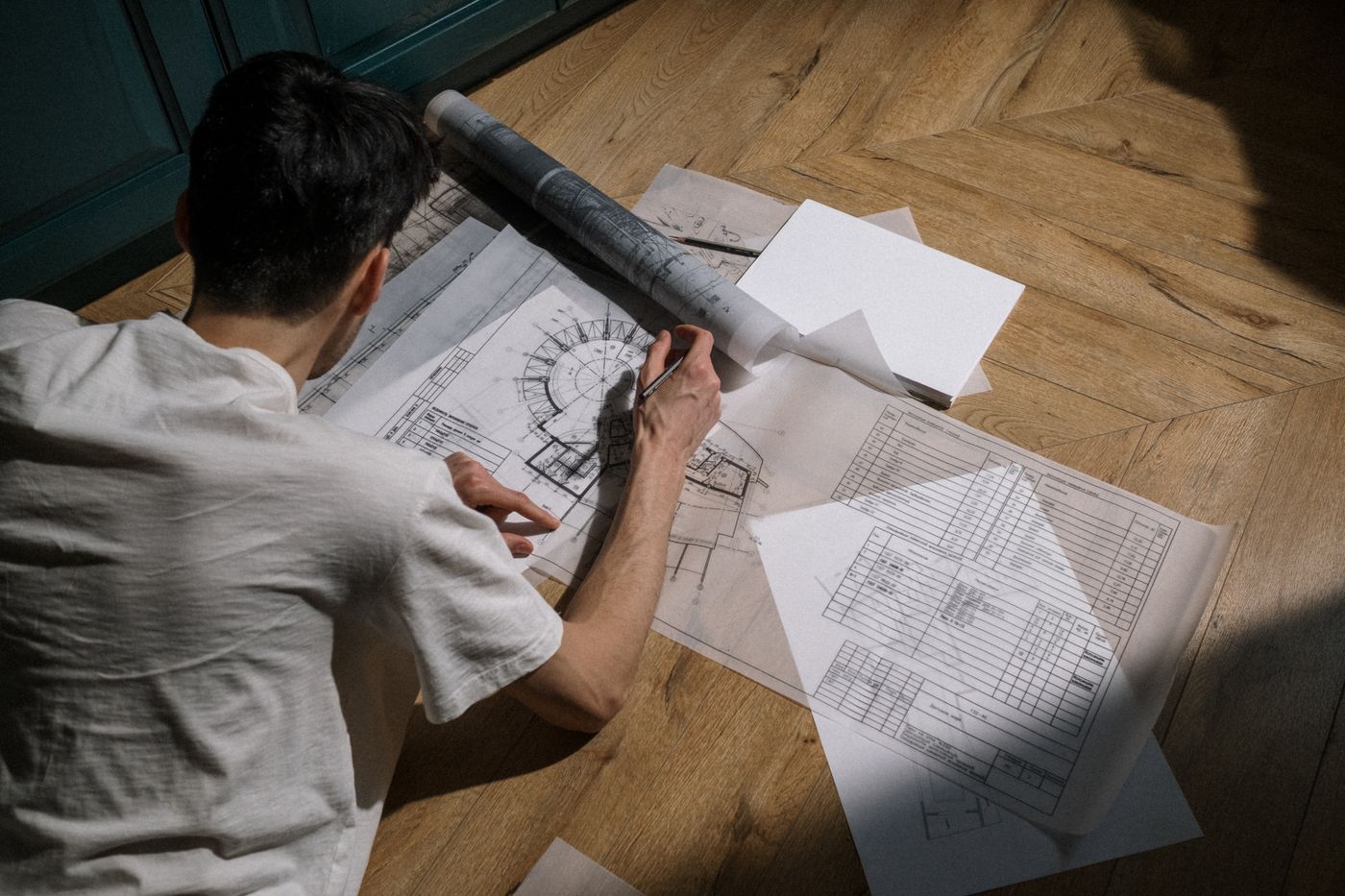 Hands drawing over technical plans
