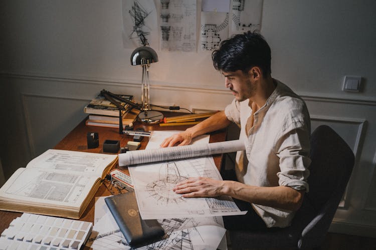 ADult Man Sitting On Chair By Deck And Drawing