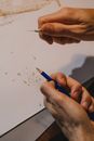 Close up on mans hands tempering pencil
