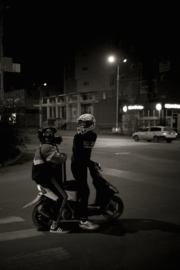 A Men Riding Moped On Road