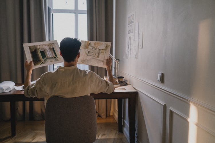 Architect Looking At Designs At Home