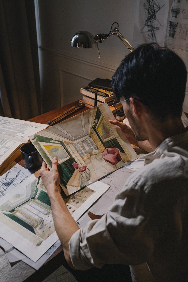 View From Behind Of Man Holding A 3D Picture