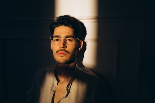 Portrait of man in eyeglasses in sunlight
