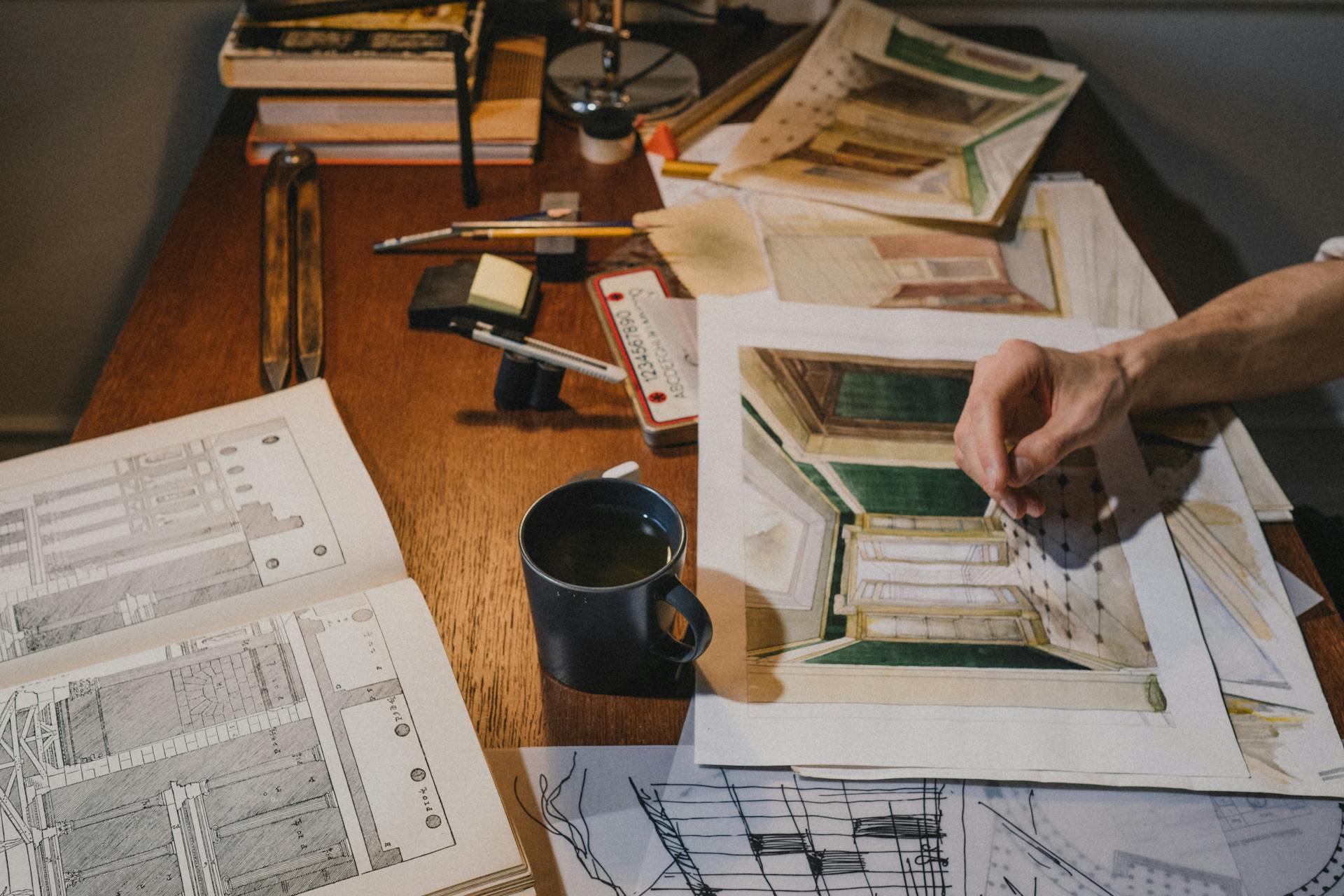 A creative workspace filled with architectural sketches and artistic tools, showcasing detailed design work.