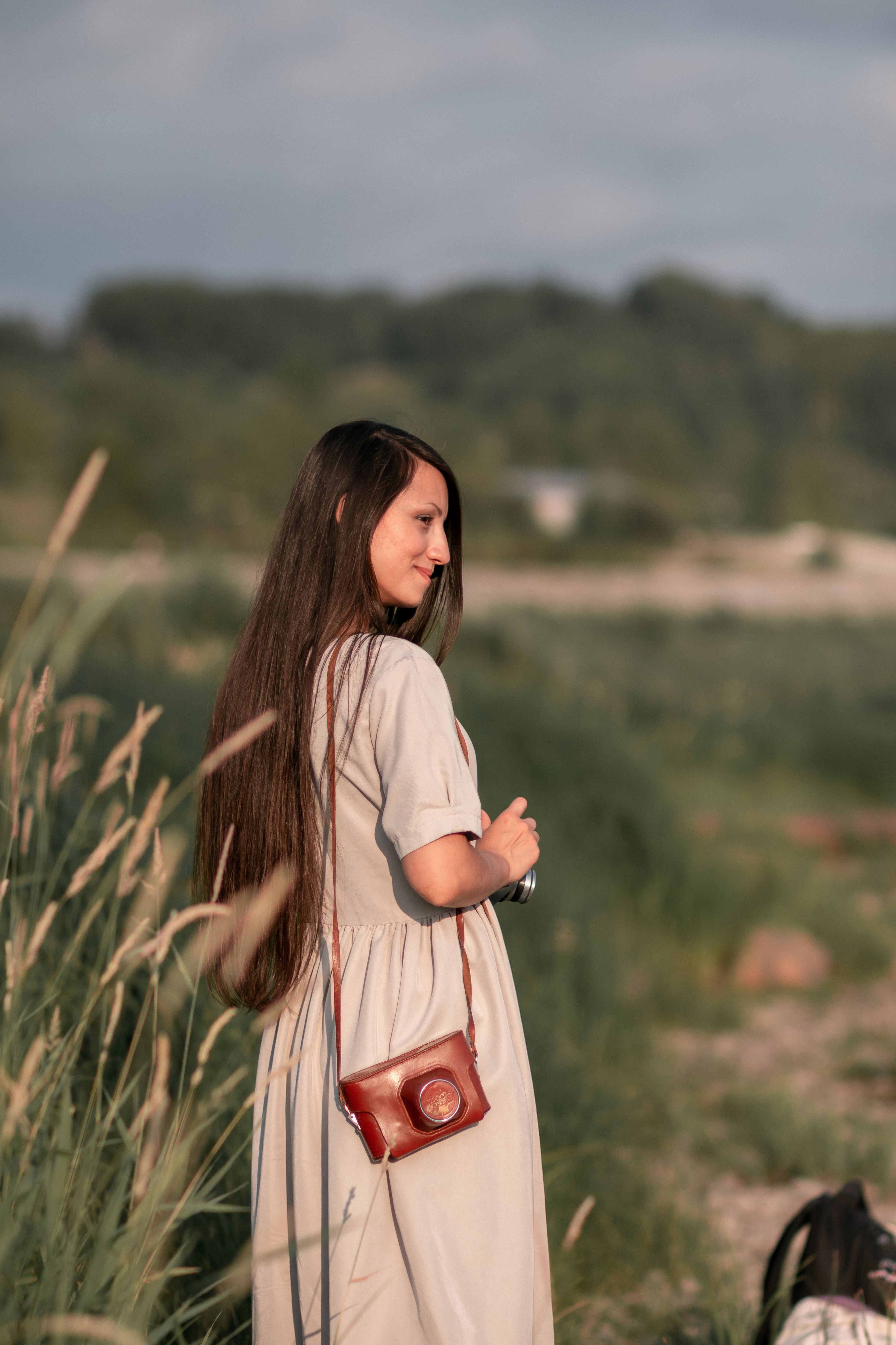 Woman in Dress Standing on Green Grass Field · Free Stock Photo