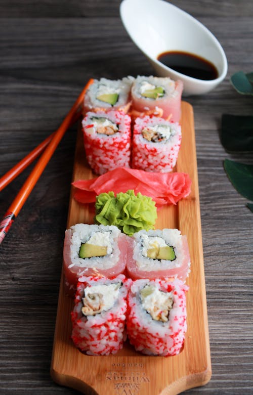 Mouthwatering Sushi Rolls on Brown Wooden Tray