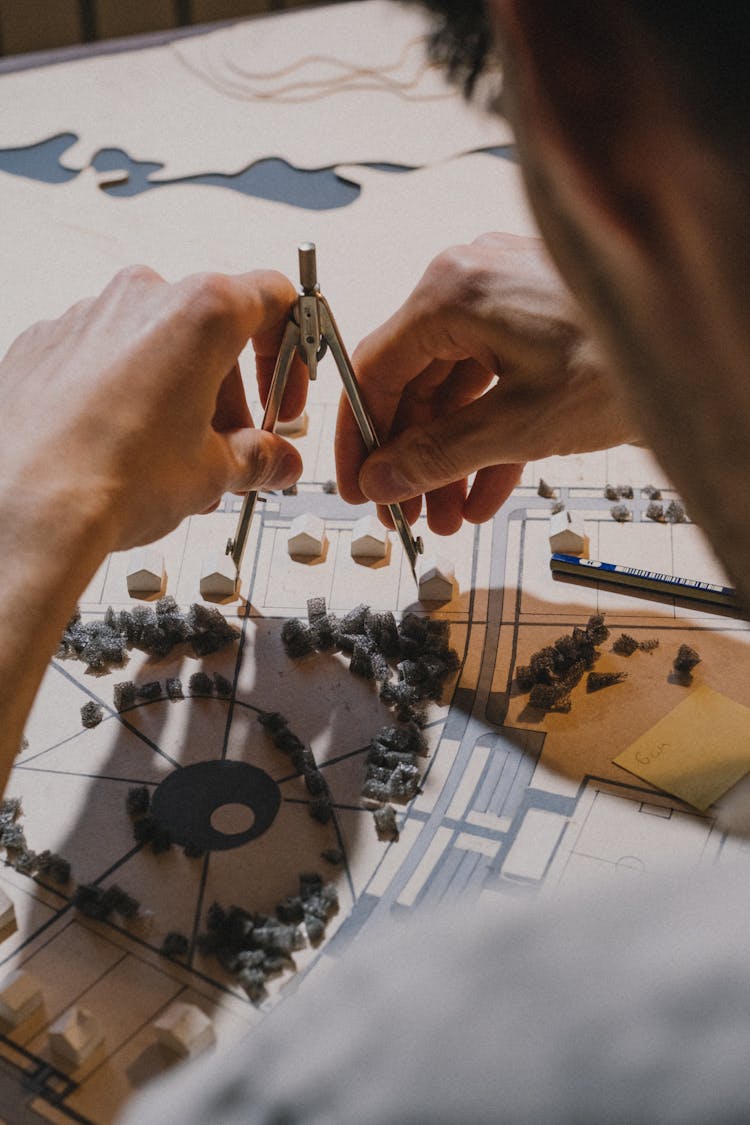 Architect Working With Model On Desk