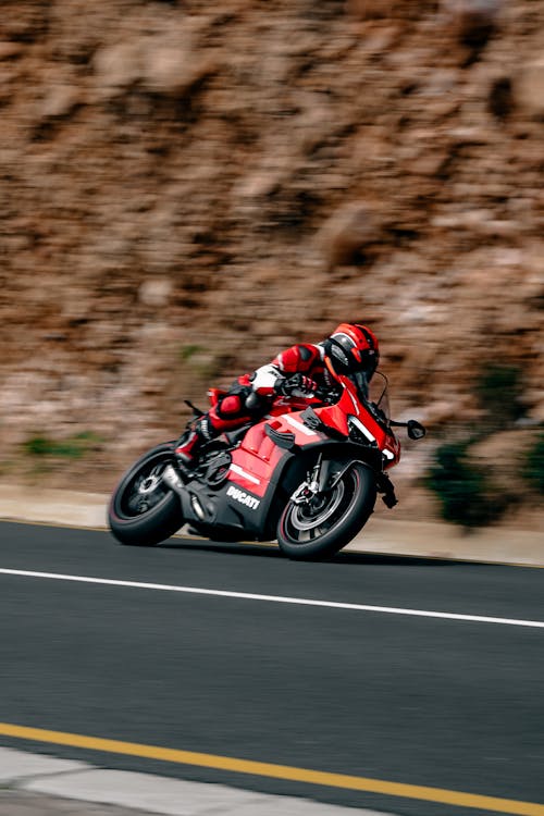 Free A Person Riding a Red Ducati Bike Stock Photo
