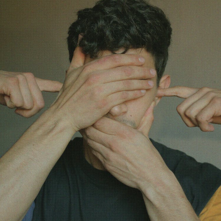 A Man Covering Face With Hands