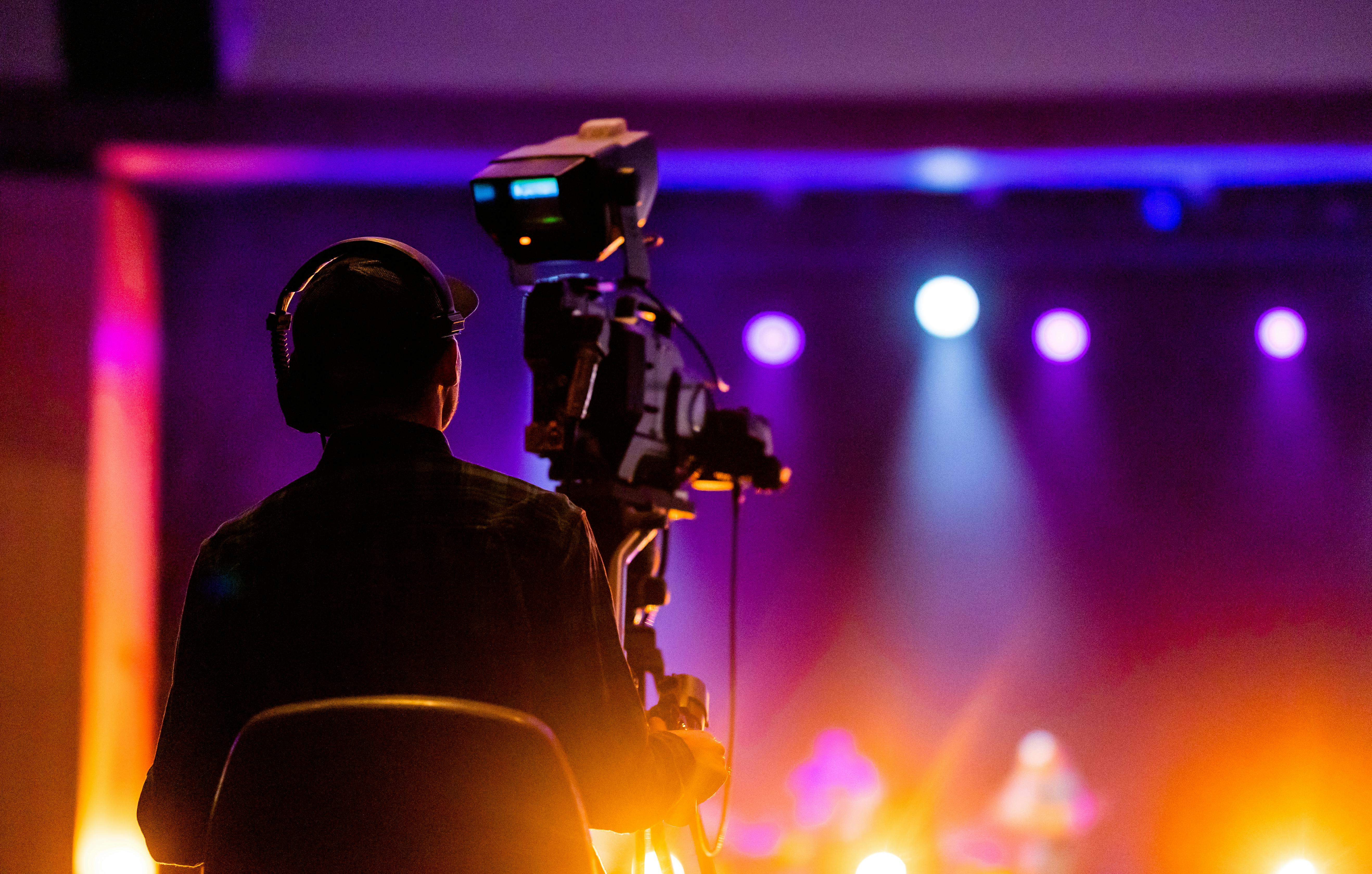 person sitting on a chair in front of a video camera