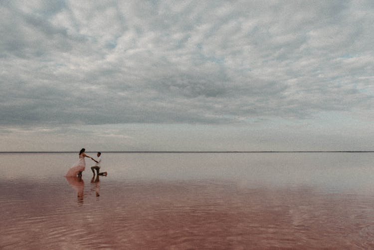 Man Making Proposal For Woman In Ocean