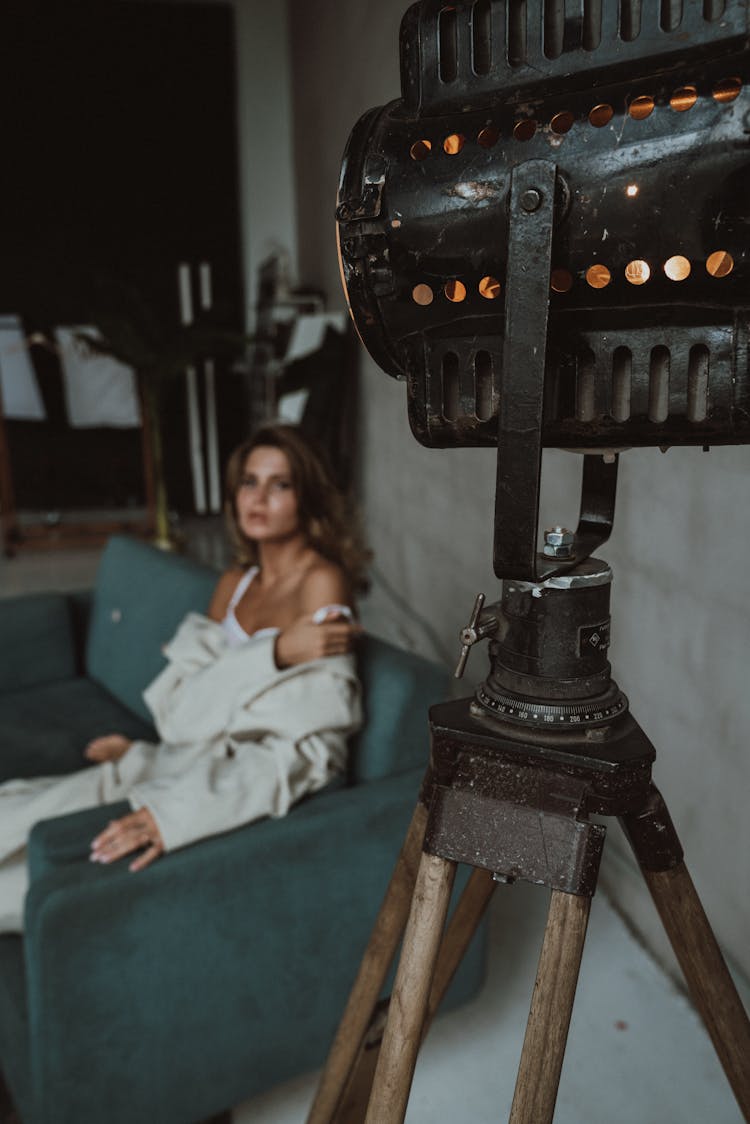 Woman Sitting On Couch Near Reflector