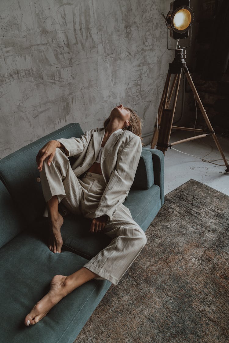 Portrait Of Woman Lying On Sofa And Looking Up