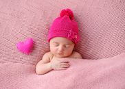 A Baby Wearing a Pink Beanie