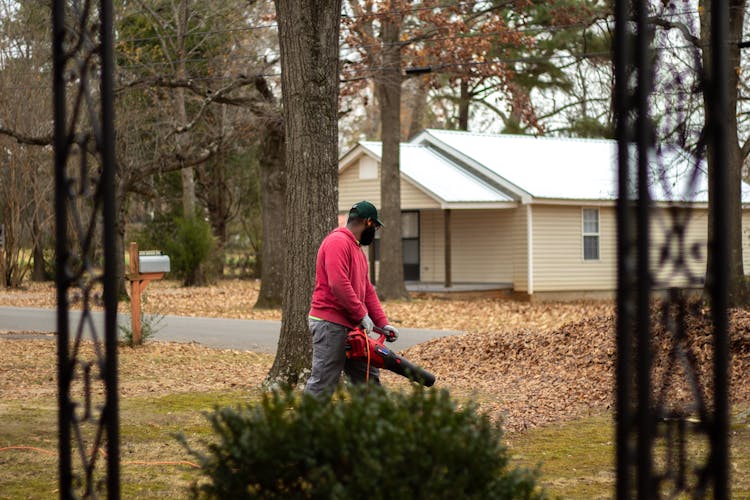 Man Working With Blower In Village