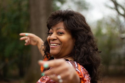 Woman in Red and White Floral Dress Smiling