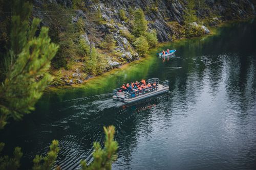 Free High-angle view of groups boating and rafting on a scenic river surrounded by nature. Stock Photo
