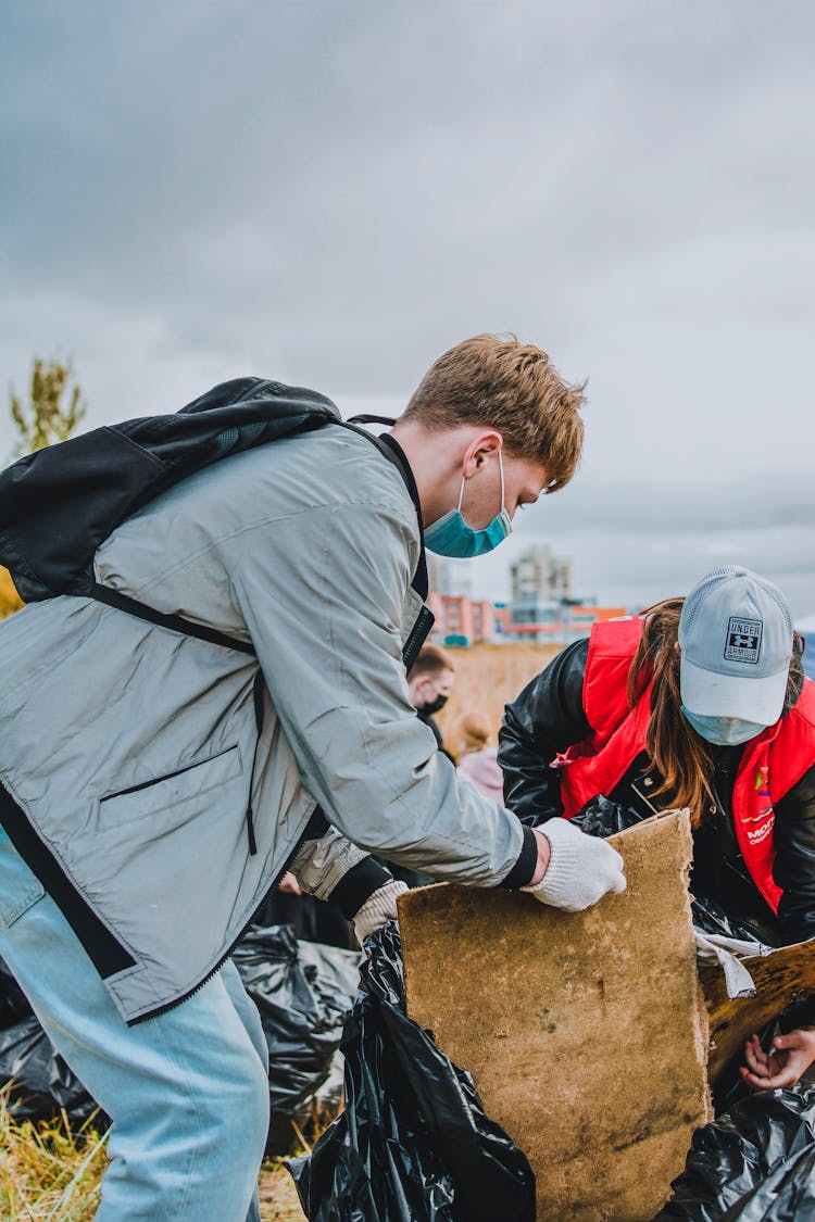 People In Face Masks Cleaning Coast